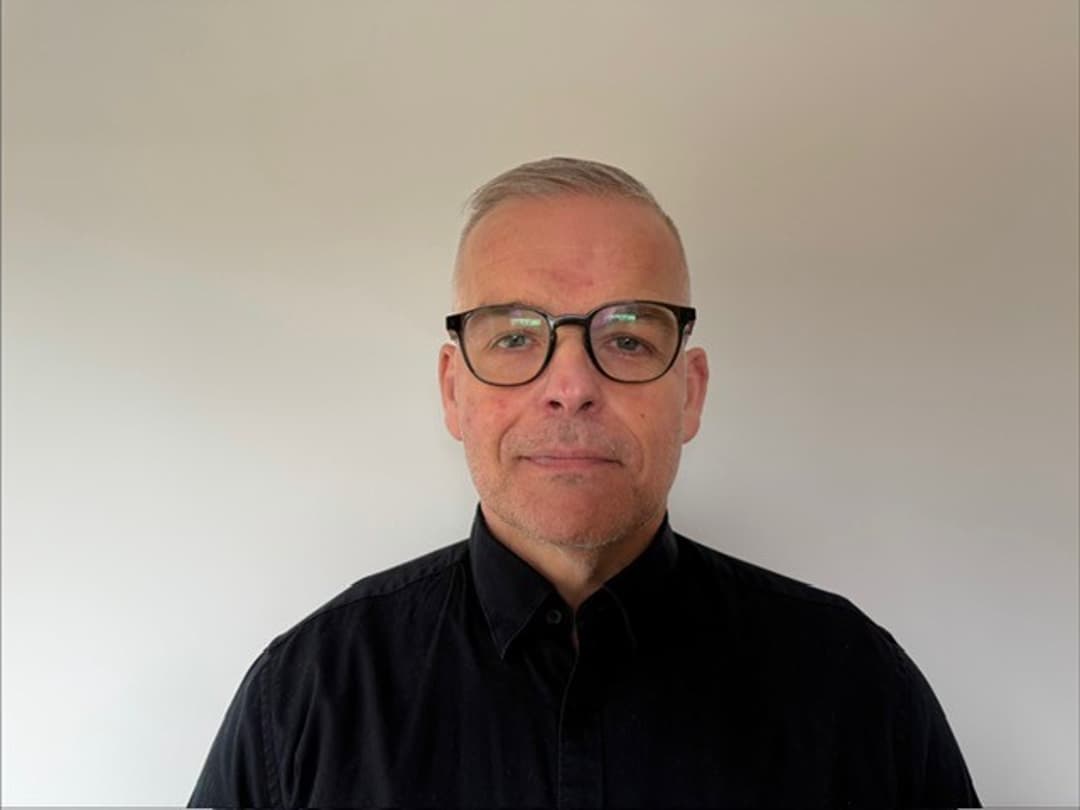 Person som står framför en vit bakgrund